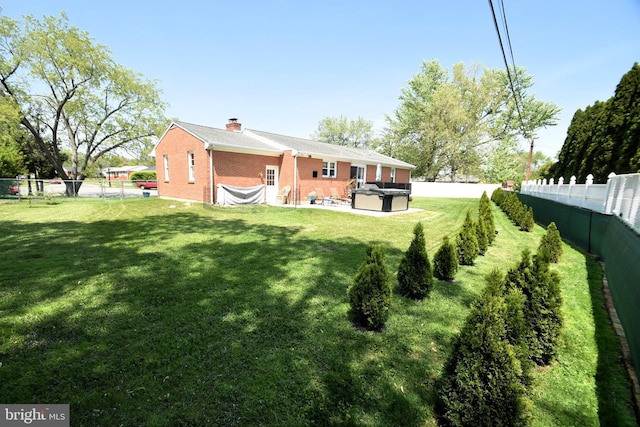 10 Casimir Ct, New Castle, DE 19720 - back of house featuring a hot tub, brick siding, a patio area, and a chimney