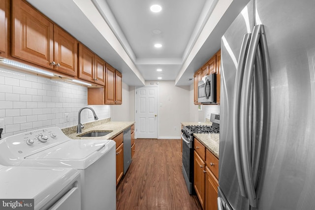 10234 Prince Pl Unit 17-T2, Upper Marlboro, MD 20774 - kitchen featuring appliances with stainless steel finishes, a sink, brown cabinets, decorative backsplash, and recessed lighting