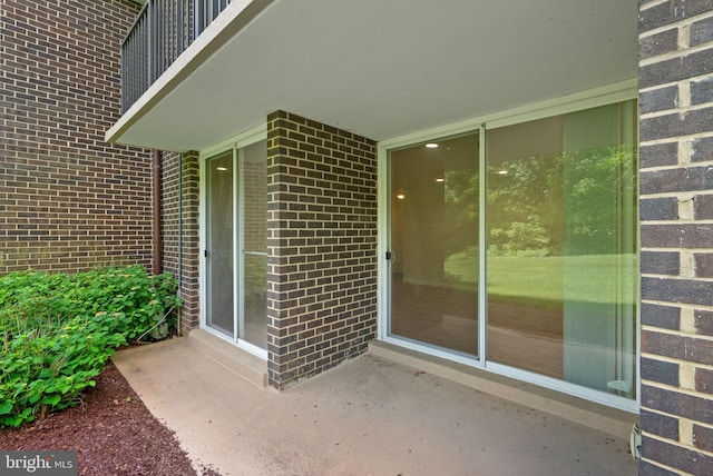 10234 Prince Pl Unit 17-T2, Upper Marlboro, MD 20774 - doorway to property featuring brick siding and a patio