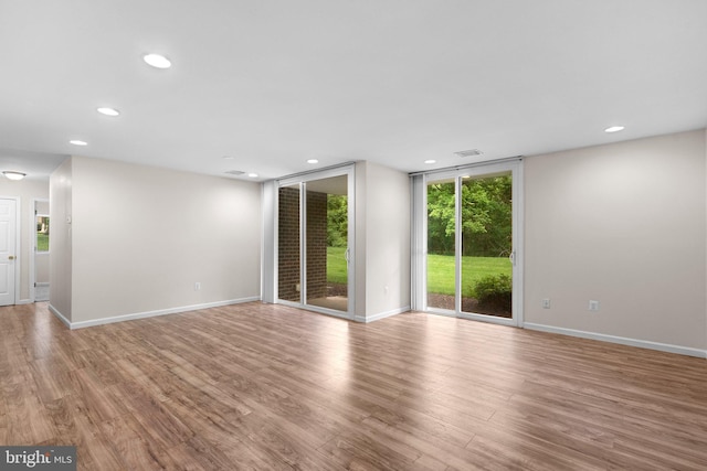 10234 Prince Pl Unit 17-T2, Upper Marlboro, MD 20774 - empty room featuring recessed lighting, wood finished floors, baseboards, and a wall of windows