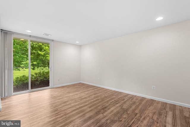 10234 Prince Pl Unit 17-T2, Upper Marlboro, MD 20774 - empty room featuring wood finished floors, recessed lighting, baseboards, and expansive windows