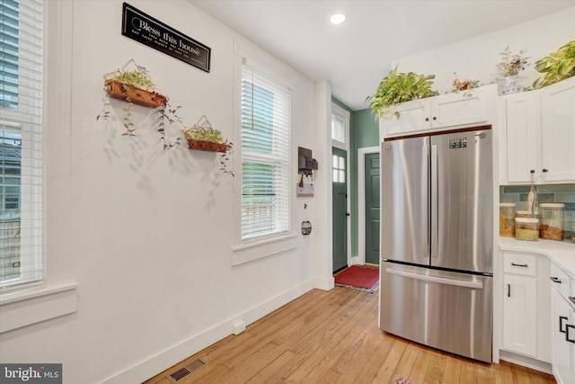 242 E Walnut St, Lancaster, PA 17602 - kitchen featuring freestanding refrigerator, light wood-style floors, white cabinets, baseboards, and light countertops