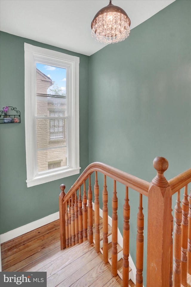 242 E Walnut St, Lancaster, PA 17602 - staircase featuring a chandelier, wood finished floors, and baseboards