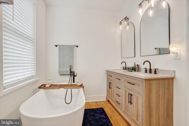 242 E Walnut St, Lancaster, PA 17602 - full bath featuring double vanity, a freestanding tub, and wood finished floors