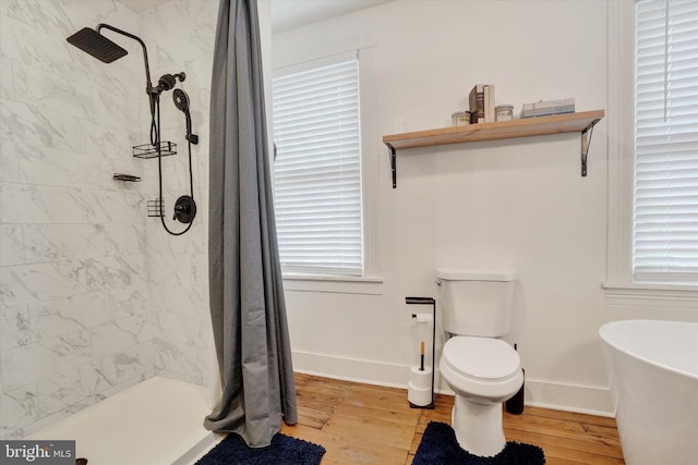 242 E Walnut St, Lancaster, PA 17602 - full bath featuring wood finished floors, a tile shower, toilet, and plenty of natural light