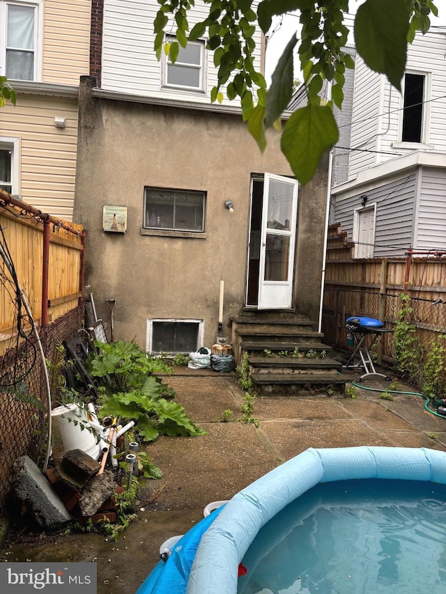 3857 N Marshall St, Philadelphia, PA 19140 - rear view of house with entry steps and stucco siding