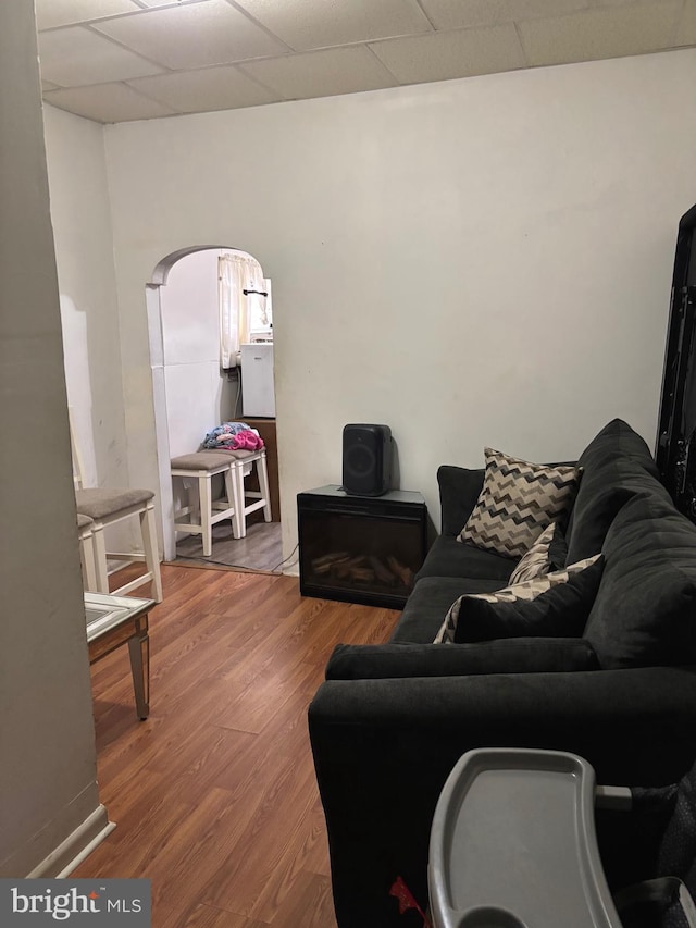 3857 N Marshall St, Philadelphia, PA 19140 - living room with wood finished floors, a drop ceiling, and arched walkways
