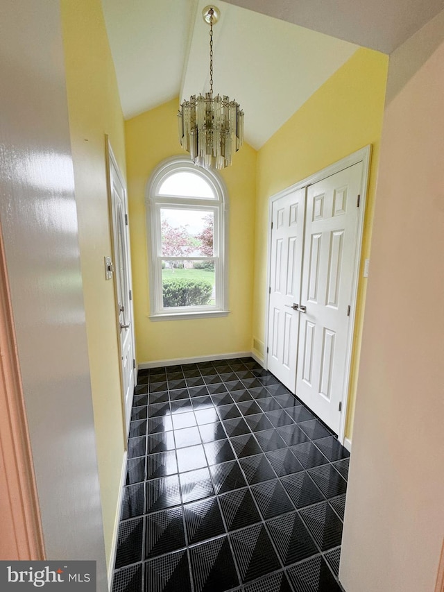 1392 Kutz Dr, Pottstown, PA 19465 - unfurnished dining area featuring a chandelier, vaulted ceiling, and dark tile patterned flooring