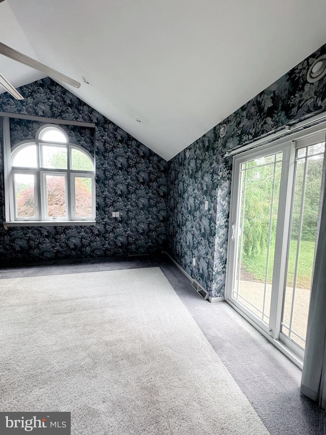 1392 Kutz Dr, Pottstown, PA 19465 - spare room with lofted ceiling, wallpapered walls, and carpet flooring