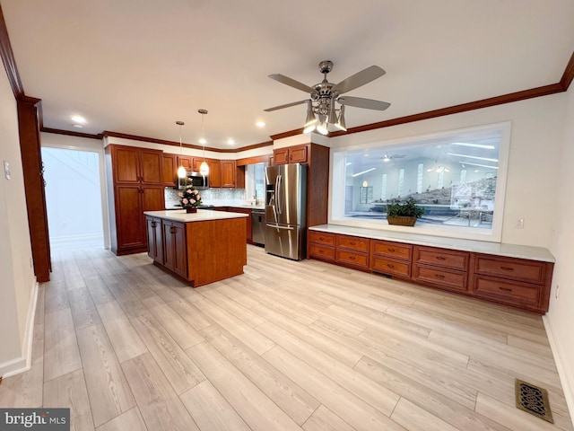 1392 Kutz Dr, Pottstown, PA 19465 - kitchen featuring stainless steel appliances, ceiling fan, brown cabinets, light countertops, and tasteful backsplash