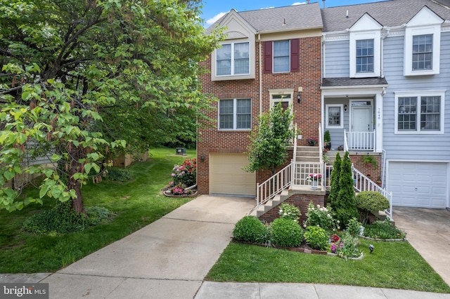view of property with a garage, brick siding, driveway, a front lawn, and stairway