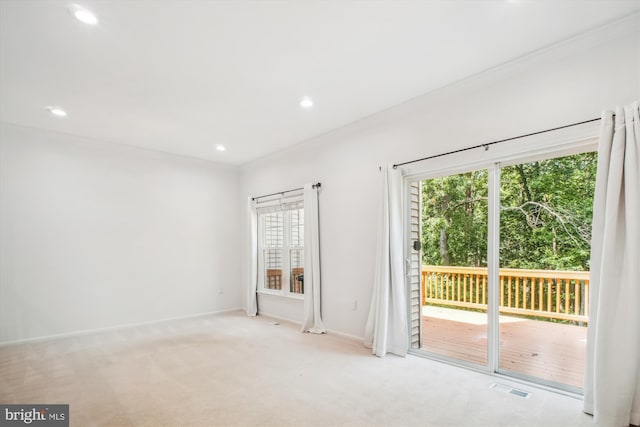 unfurnished room with recessed lighting, light colored carpet, crown molding, and baseboards