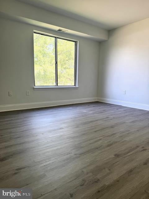 106 Mountain Rd Unit 2C, Glen Burnie, MD 21060 - empty room featuring dark wood-type flooring and baseboards