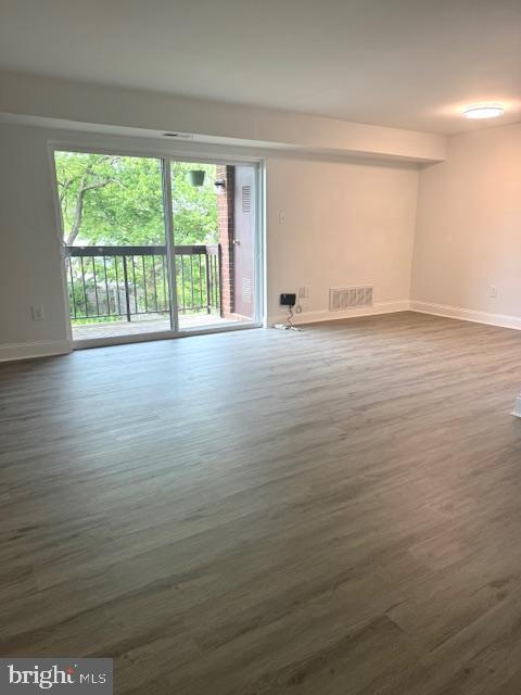106 Mountain Rd Unit 2C, Glen Burnie, MD 21060 - spare room with baseboards and dark wood finished floors