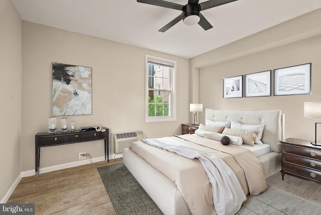 230 N Thomas St Unit 230-3, Arlington, VA 22203 - bedroom featuring wood finished floors, a wall mounted AC, baseboards, and ceiling fan