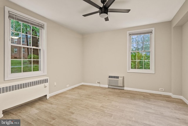 230 N Thomas St Unit 230-3, Arlington, VA 22203 - empty room featuring radiator heating unit, plenty of natural light, and light wood-style floors