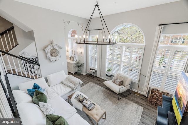 1885 Crescent Park Dr, Reston, VA 20190 - living area with a chandelier, stairway, wood finished floors, and baseboards