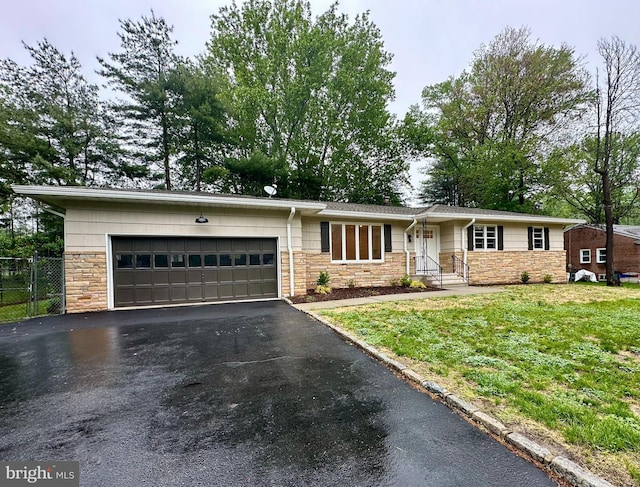 ranch-style house with stone siding, a garage, and driveway