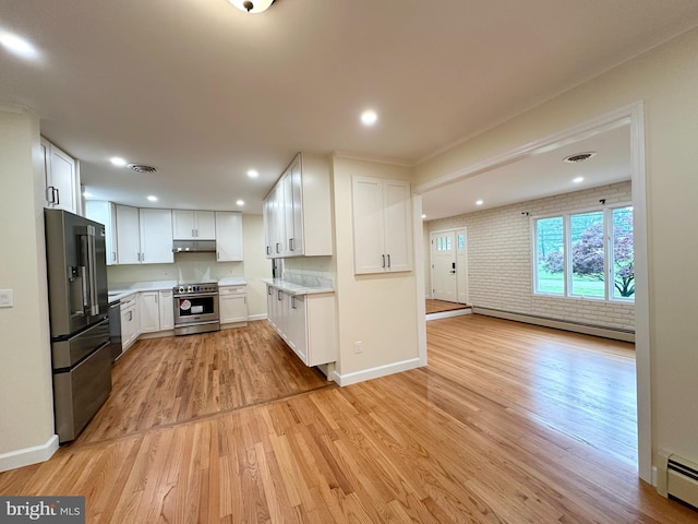 kitchen with appliances with stainless steel finishes, baseboard heating, under cabinet range hood, light wood-style flooring, and recessed lighting