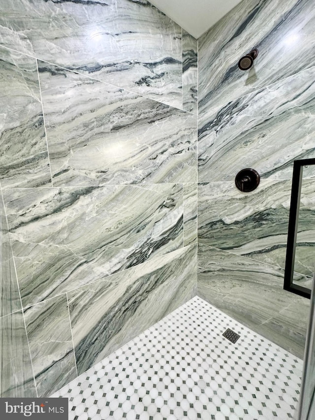 bathroom with a marble finish shower