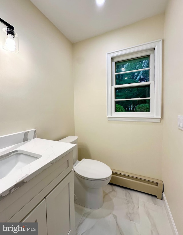 bathroom with a baseboard heating unit, marble look tile flooring, vanity, and toilet