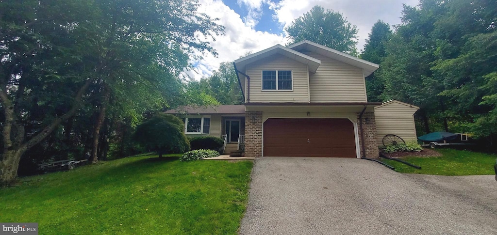 2980 Honey Valley Rd, Dallastown, PA 17313 - traditional home with asphalt driveway, a garage, a front yard, and brick siding