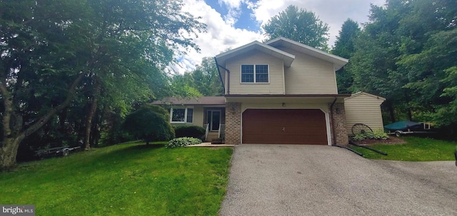2980 Honey Valley Rd, Dallastown, PA 17313 - traditional home with asphalt driveway, a garage, a front yard, and brick siding