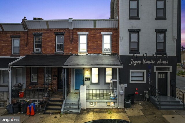 2562 N 31st St, Philadelphia, PA 19132 - view of property featuring covered porch, brick siding, entry steps, and a chimney