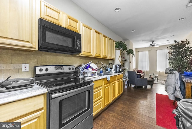 2562 N 31st St, Philadelphia, PA 19132 - kitchen featuring black microwave, stainless steel electric stove, a sink, light countertops, and open floor plan