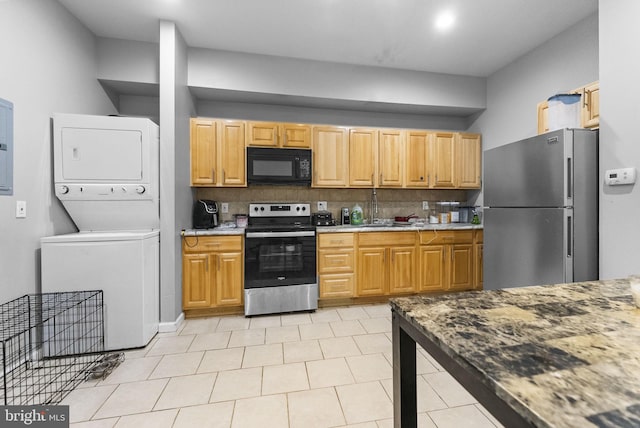 2562 N 31st St, Philadelphia, PA 19132 - kitchen featuring appliances with stainless steel finishes, stacked washer and clothes dryer, backsplash, a sink, and electric panel