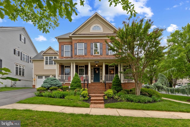 12501 Boulder Heights Ter, Clarksburg, MD 20871 - view of front of property with covered porch, an attached garage, brick siding, asphalt driveway, and a front yard
