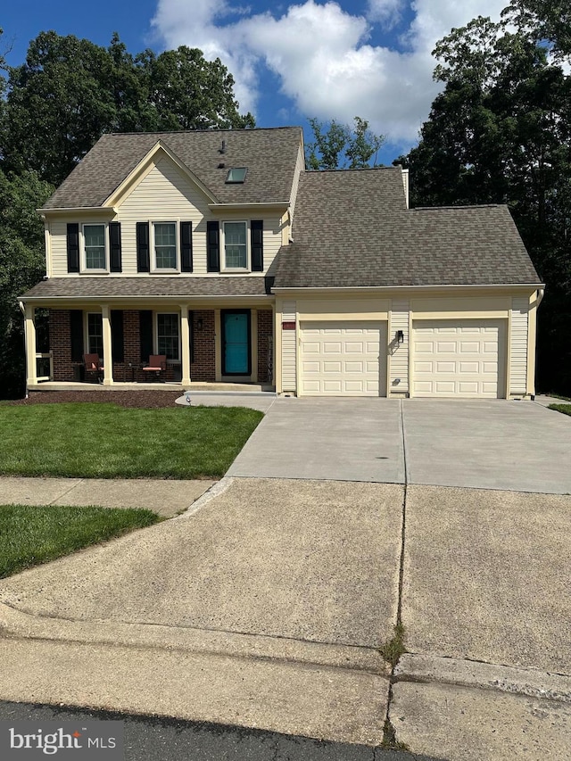 view of front of house with an attached garage, concrete driveway, covered porch, and a shingled roof