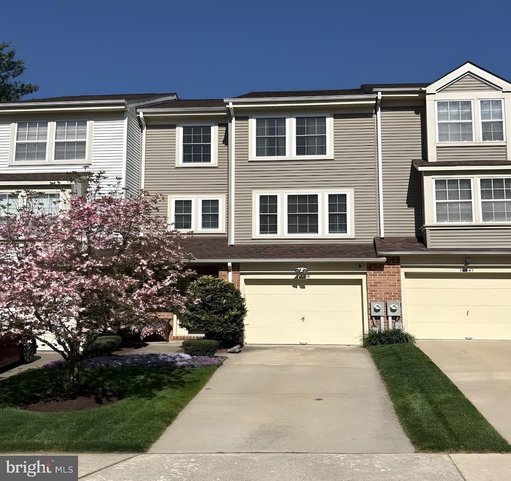 10939 Baskerville Rd, Reisterstown, MD 21136 - townhome / multi-family property featuring driveway, an attached garage, and brick siding