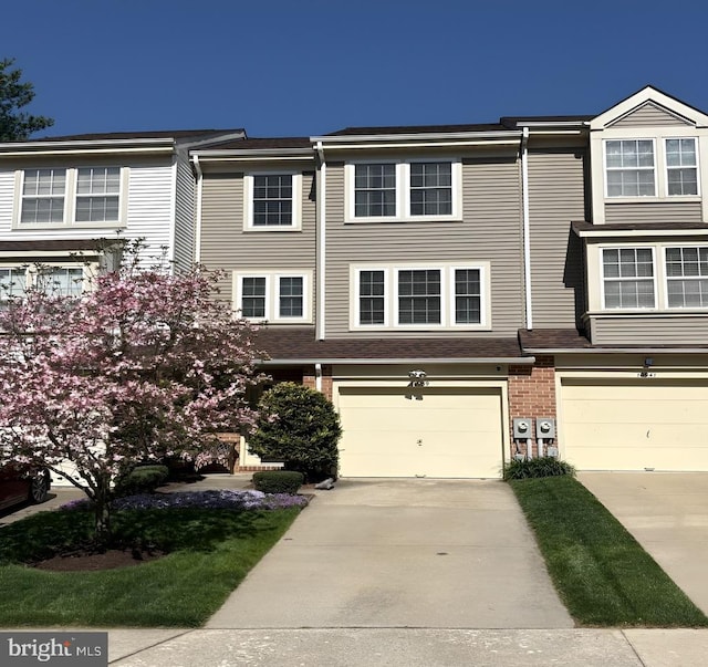 10939 Baskerville Rd, Reisterstown, MD 21136 - townhome / multi-family property featuring driveway, an attached garage, and brick siding