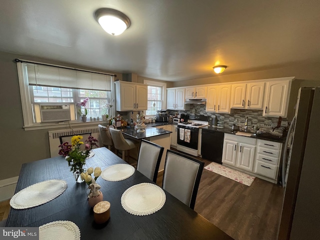 3110 Wellington St, Philadelphia, PA 19149 - kitchen featuring gas range oven, freestanding refrigerator, dishwasher, radiator, and dark countertops