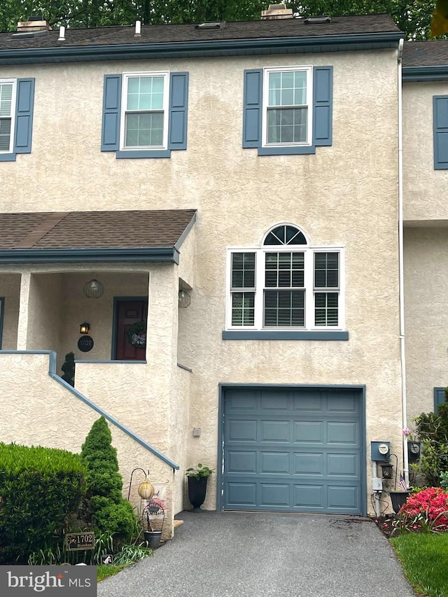 1702 Stoneham Dr, West Chester, PA 19382 - view of property with stucco siding, asphalt driveway, and an attached garage
