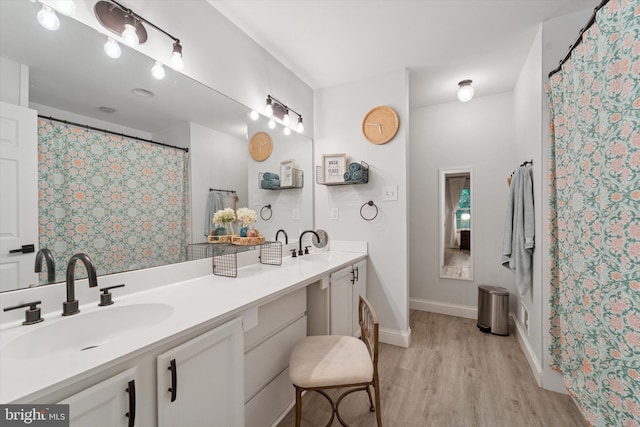 1702 Stoneham Dr, West Chester, PA 19382 - bathroom with wood finished floors, double vanity, and baseboards