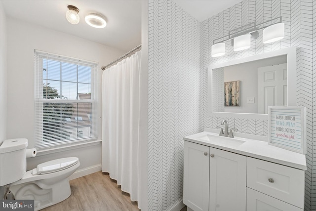 1702 Stoneham Dr, West Chester, PA 19382 - bathroom with toilet, wallpapered walls, wood finished floors, vanity, and baseboards