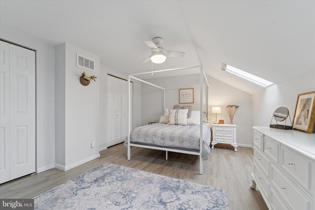 1702 Stoneham Dr, West Chester, PA 19382 - bedroom featuring wood finished floors, a skylight, two closets, baseboards, and lofted ceiling