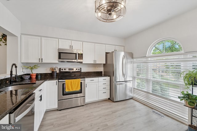 1702 Stoneham Dr, West Chester, PA 19382 - kitchen with appliances with stainless steel finishes, a sink, white cabinets, and dark stone countertops