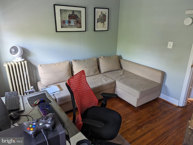 living area featuring an office area, wood finished floors, and baseboards