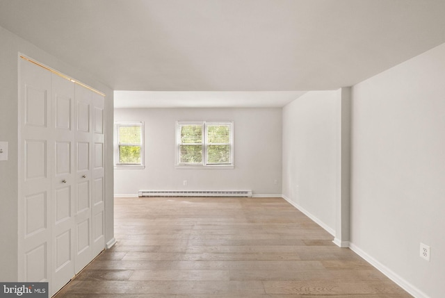 513 Tavenner Ct, Sterling, VA 20164 - unfurnished bedroom with a baseboard heating unit, light wood-style floors, a closet, and baseboards