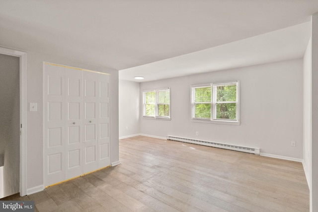 513 Tavenner Ct, Sterling, VA 20164 - unfurnished bedroom featuring baseboard heating, light wood-style flooring, baseboards, and a closet