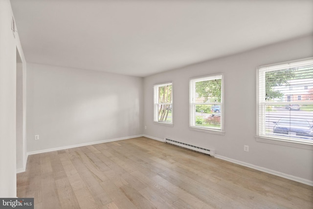 513 Tavenner Ct, Sterling, VA 20164 - empty room with a baseboard heating unit, light wood-style floors, and baseboards