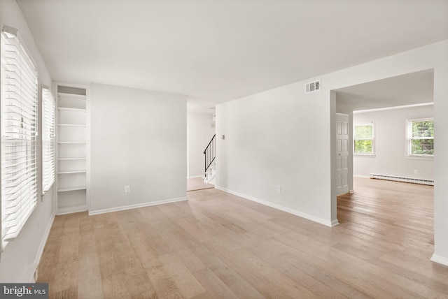 513 Tavenner Ct, Sterling, VA 20164 - unfurnished room featuring light wood-style floors, baseboard heating, stairs, and baseboards