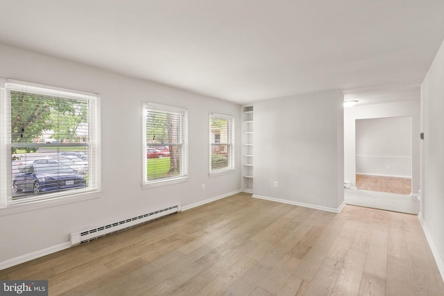 513 Tavenner Ct, Sterling, VA 20164 - unfurnished room featuring a baseboard radiator, light wood-style flooring, built in shelves, and baseboards