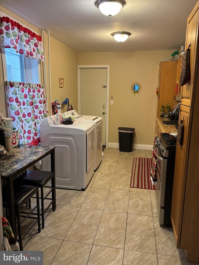 3737 N 5th St, Philadelphia, PA 19140 - washroom featuring independent washer and dryer, light tile patterned flooring, and baseboards