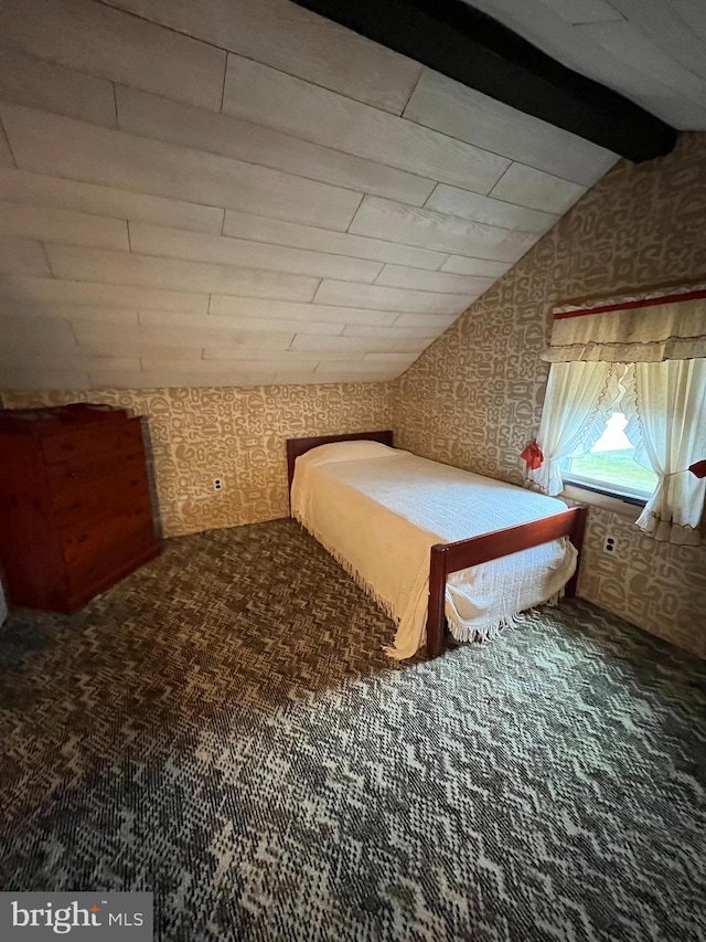 bedroom with wallpapered walls and carpet floors