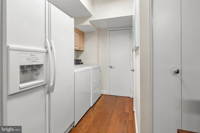 10 Stonehenge Cir Unit 1, Pikesville, MD 21208 - clothes washing area featuring washing machine and clothes dryer, cabinet space, and light wood finished floors