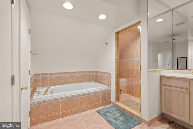 full bath with a stall shower, a bath, tile patterned flooring, vaulted ceiling, and vanity